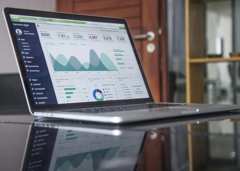 Laptop showing marketing performance charts for a marketing assessment